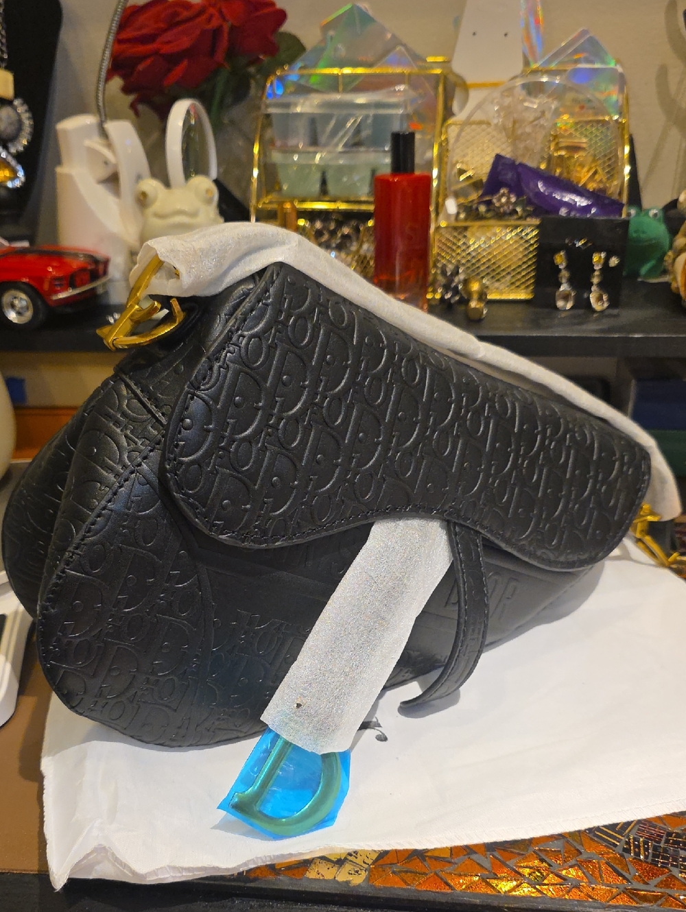 Black Embossed Saddle Crossbody Bag with Gold Hardware